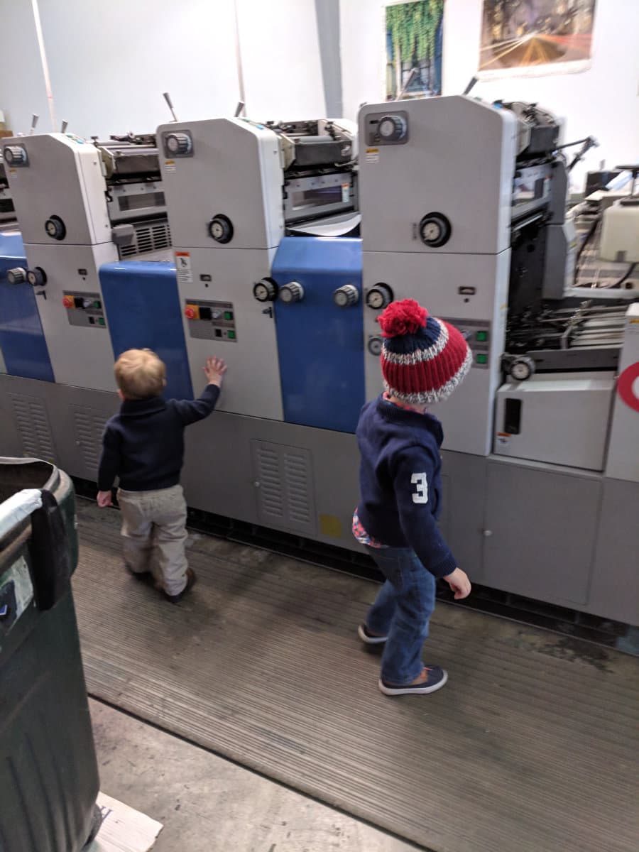 Family working at the press in the original Springfield shop